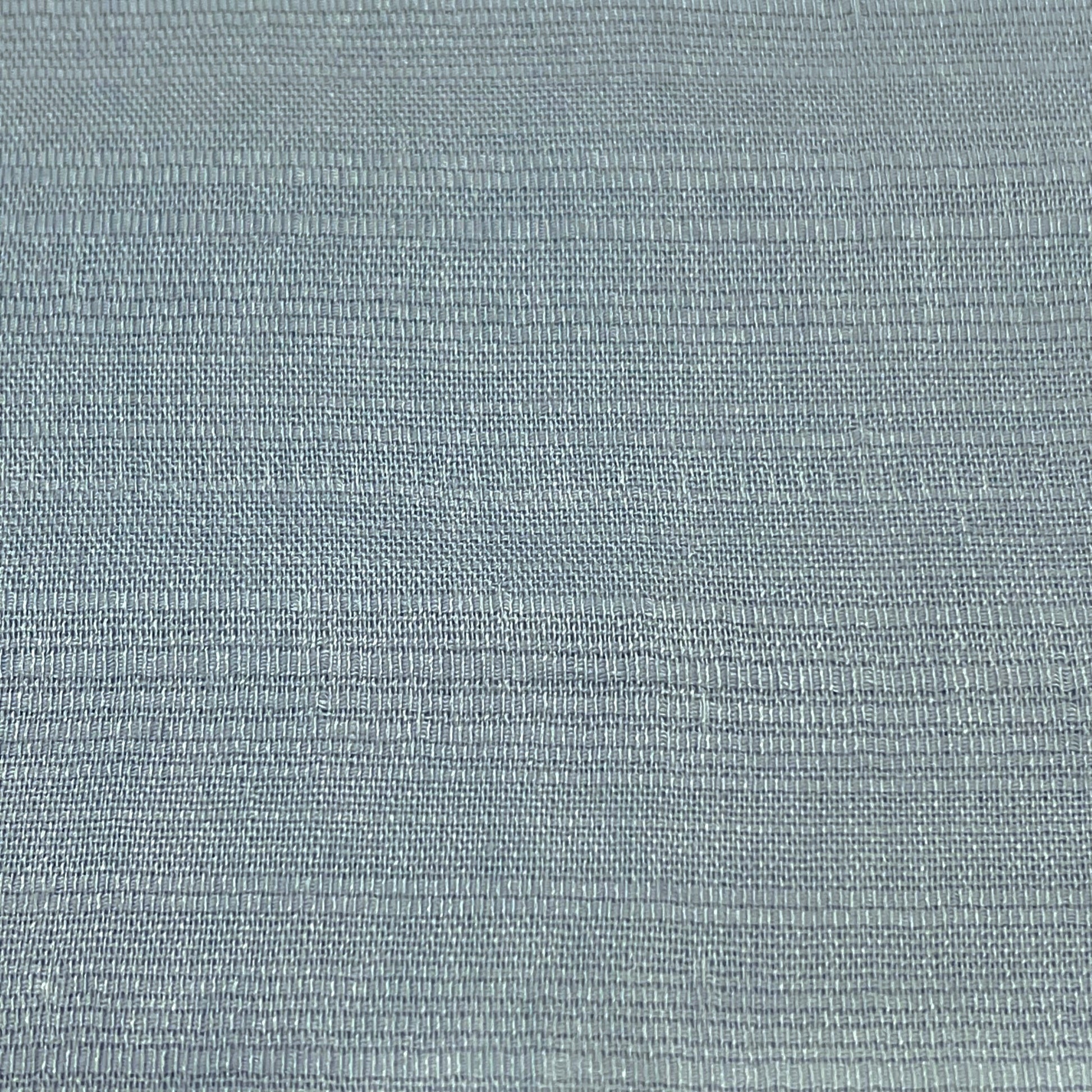 Close-up of a soft, solid light blue Thai silk fabric, showcasing its delicate texture and luxurious feel.