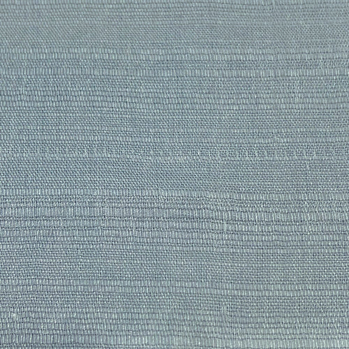 Close-up of a soft, solid light blue Thai silk fabric, showcasing its delicate texture and luxurious feel.